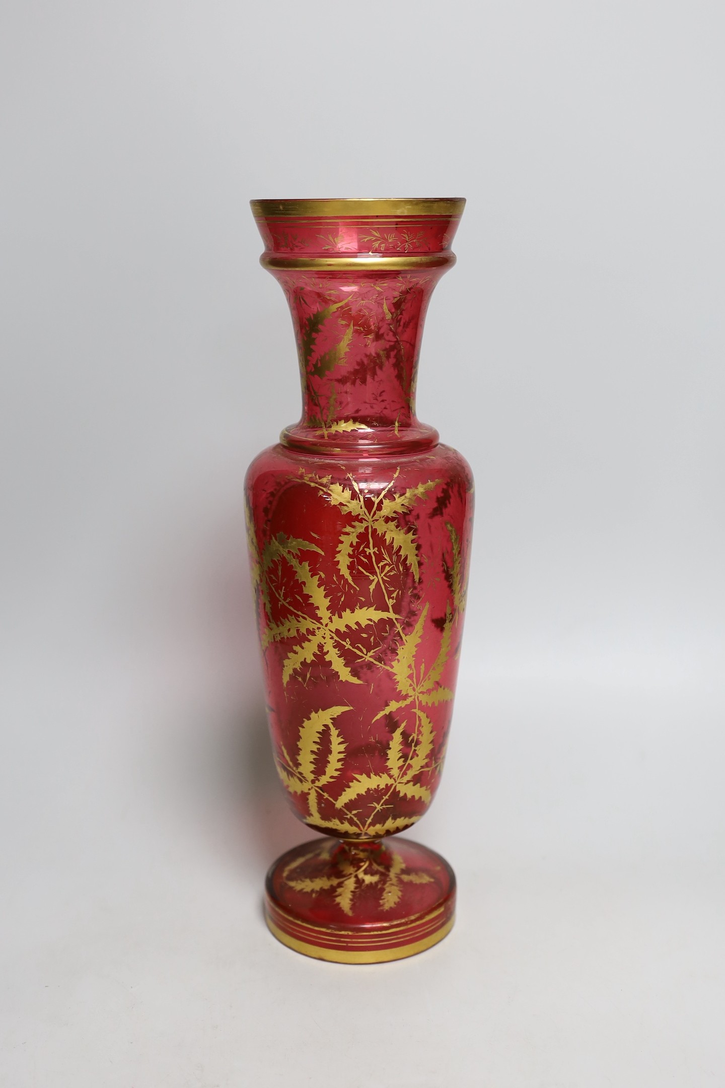 A 19th century Bohemian overlaid cranberry glass vase, 37cm tall